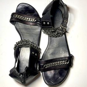 Stuart Weitzman black flat sandals with thick ankle chain detail
